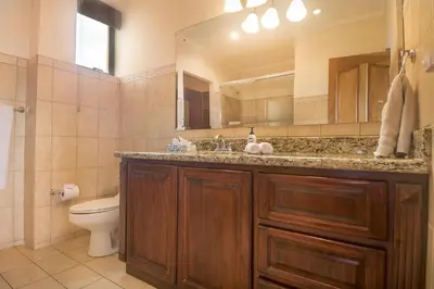 a bathroom with a sink and a toilet and a mirror at Oceanica 824 in Playa Flamingo
