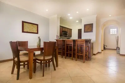 a dining room and kitchen with a table and chairs at Oceanica 824 in Playa Flamingo