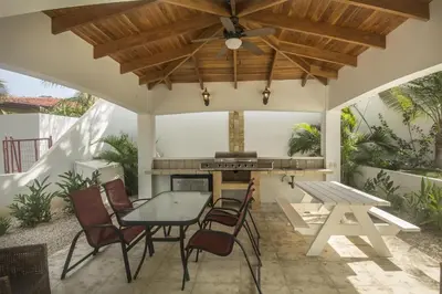 a patio with a table and chairs and a stove at Oceanica 824 in Playa Flamingo