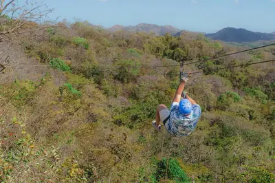 a person is hanging on a zip line at Oceanica 824 in Playa Flamingo