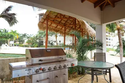 a grill on a patio with a table and chairs at Oceanica 824 in Playa Flamingo