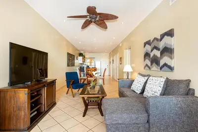 a living room with a couch and a flat screen tv at Sunrise 23- 2 Bedroom Ocean View Condo in Tamarindo