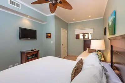 a bedroom with a bed and a ceiling fan at Sunrise 23- 2 Bedroom Ocean View Condo in Tamarindo