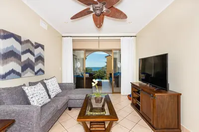 a living room with a couch and a flat screen tv at Sunrise 23- 2 Bedroom Ocean View Condo in Tamarindo