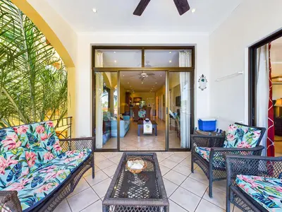 a living room with two chairs and a table at Sunrise 38- Ocean View 2 Br Condo, Steps To The Beach in Tamarindo