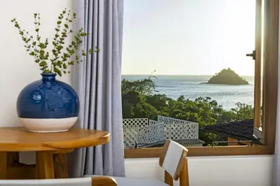 a blue vase sitting on a table in front of a window at Paseo Miraflores 8 At Las Catalinas in Tempate