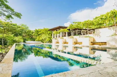 an image of a swimming pool in front of a house at Paseo Miraflores 8 At Las Catalinas in Tempate
