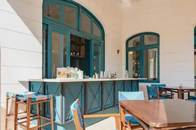 a patio with tables and chairs and a bar at Paseo Miraflores 8 At Las Catalinas in Tempate