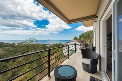 a balcony with chairs and a view of the ocean at Casa De La Perla, Ocean View 4 Bedroom Home in Tamarindo
