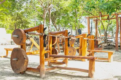 a group of wooden playground equipment in a park at Paseo Miraflores 7 At Las Catalinas in Tempate