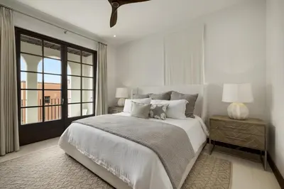 a white bedroom with a large bed and a window at Paseo Miraflores 7 At Las Catalinas in Tempate