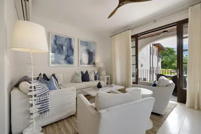 a living room with white furniture and a table at Paseo Miraflores 7 At Las Catalinas in Tempate