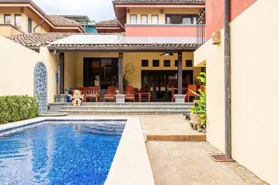 a house with a swimming pool in front of a house at Jade Coast 3- Private 5 Bedroom Villa in Tamarindo