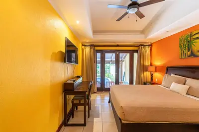 a bedroom with a bed and a ceiling fan at Jade Coast 3- Private 5 Bedroom Villa in Tamarindo