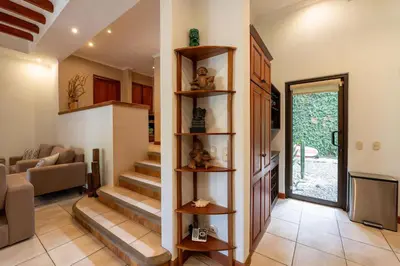 a living room with a staircase in a house at Jade Coast 3- Private 5 Bedroom Villa in Tamarindo