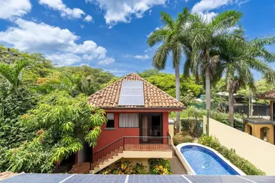 a house with a swimming pool and a resort at Jade Coast 3- Private 5 Bedroom Villa in Tamarindo