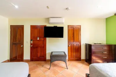 a bedroom with a bed and a tv on the wall at Jade Coast 3- Private 5 Bedroom Villa in Tamarindo