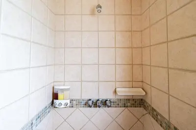 a tiled shower with a soap dispenser in a bathroom at Jade Coast 3- Private 5 Bedroom Villa in Tamarindo