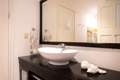 a bathroom with a sink and a large mirror at Sunrise 12- 2 Bedroom Penthouse in Tamarindo