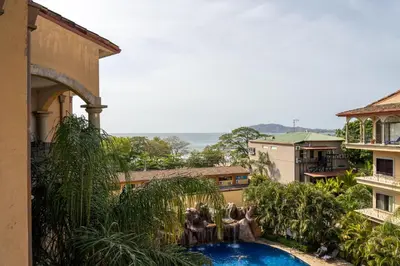 a view of a swimming pool from a building at Sunrise 12- 2 Bedroom Penthouse in Tamarindo