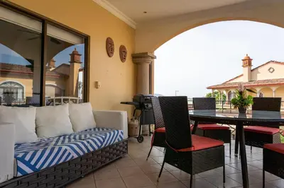a living room with a couch and a table at Sunrise 12- 2 Bedroom Penthouse in Tamarindo