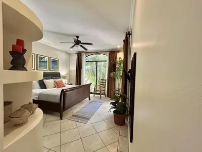 a bedroom with a bed and a ceiling fan at Sunrise 1- 3 Bedroom Poolside Condo in Tamarindo