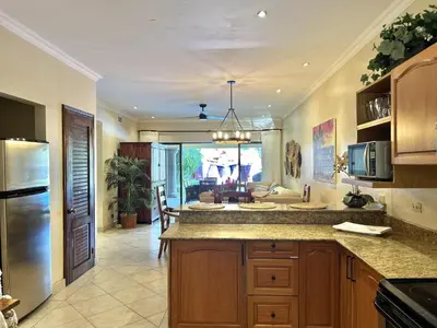 a kitchen with a large island in a room at Sunrise 1- 3 Bedroom Poolside Condo in Tamarindo