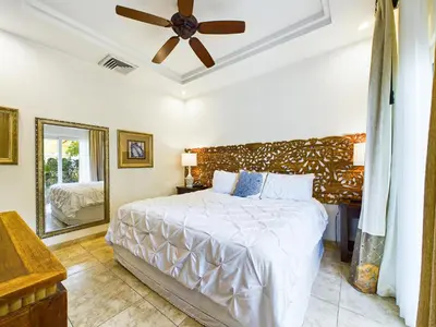 a bedroom with a bed and a ceiling fan at Matapalo 101- 3 Bedroom Poolside Luxury Condo At Tamarindo in Tamarindo
