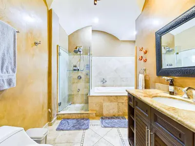 a bathroom with a shower and a sink and a tub at Matapalo 101- 3 Bedroom Poolside Luxury Condo At Tamarindo in Tamarindo