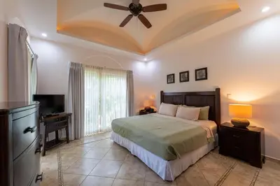 a bedroom with a bed and a ceiling fan at Matapalo 204- 2 Bedroom Condo At Tamarindo in Tamarindo