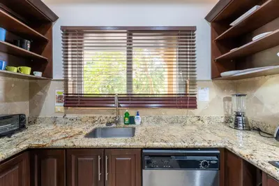 a kitchen with a sink and a window at Matapalo 204- 2 Bedroom Condo At Tamarindo in Tamarindo