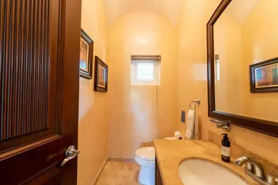 a bathroom with a sink and a toilet and a mirror at Matapalo 204- 2 Bedroom Condo At Tamarindo in Tamarindo