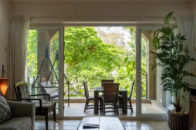 a living room with a table and chairs at Matapalo 204- 2 Bedroom Condo At Tamarindo in Tamarindo