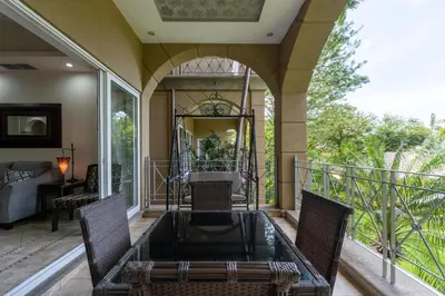 a patio with a table and chairs on a balcony at Matapalo 204- 2 Bedroom Condo At Tamarindo in Tamarindo