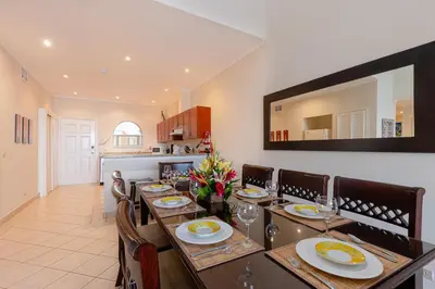 a dining room with a long table with chairs at Sunrise 48- 3 Bedroom Ocean View Penthouse Condo in Tamarindo
