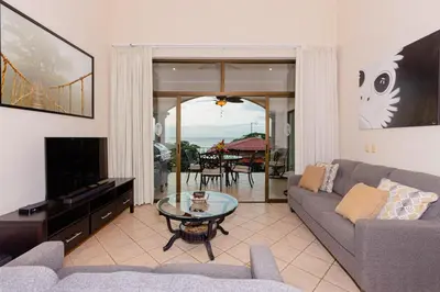 a living room with a couch and a table at Sunrise 48- 3 Bedroom Ocean View Penthouse Condo in Tamarindo