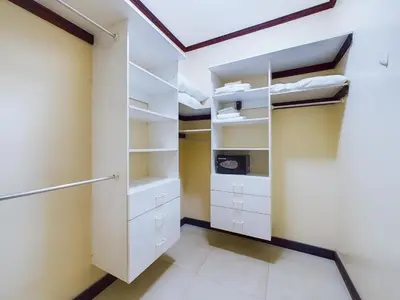 a walk in closet with white cabinets and shelves at Catalina Cove 3- 6 Bedroomloft Home in Brasilito