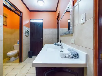 a bathroom with a sink and a toilet at Catalina Cove 3- 6 Bedroomloft Home in Brasilito