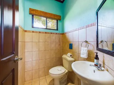 a bathroom with a toilet and a sink at Catalina Cove 3- 6 Bedroomloft Home in Brasilito