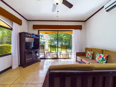 a living room with a couch and a tv at Catalina Cove 3- 6 Bedroomloft Home in Brasilito