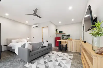 a bedroom with a bed and a couch in a room at Pipa's Surf House Marbella Guanacaste in Cuajiniquil