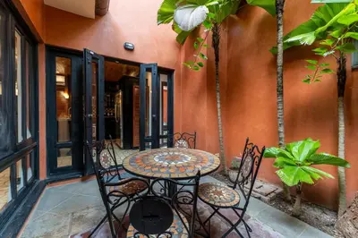an outdoor patio with a table and chairs at Villa Cerca Del Mar #6- 3Br House With Pool in Tamarindo