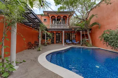 a house with a swimming pool in front of a house at Villa Cerca Del Mar #6- 3Br House With Pool in Tamarindo