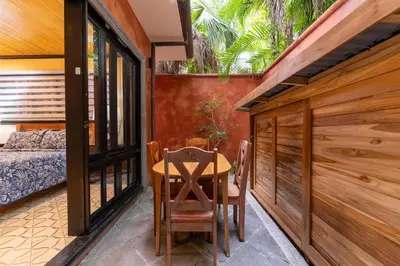 a room with a table and chairs and a bed at Villa Cerca Del Mar #6- 3Br House With Pool in Tamarindo