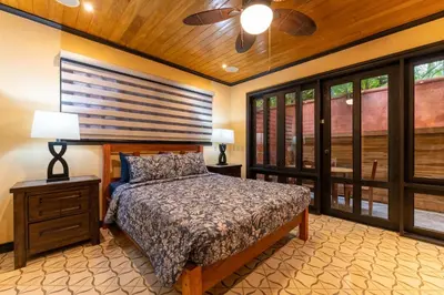 a bedroom with a bed and a ceiling fan at Villa Cerca Del Mar #6- 3Br House With Pool in Tamarindo
