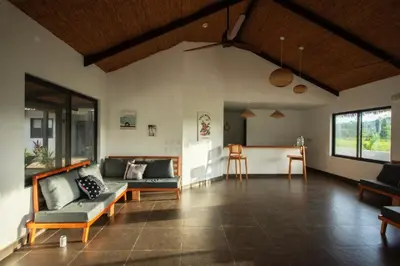a living room with couches and a table in it at Yuli Hotel in Uvita