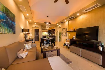 a living room with a couch and a tv at Matapalo 605- 2 Bedroom Ocean View Condo At Tamarindo in Tamarindo