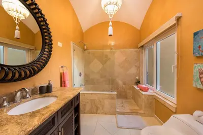 a bathroom with a shower and a sink and a mirror at Matapalo 605- 2 Bedroom Ocean View Condo At Tamarindo in Tamarindo