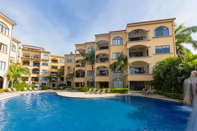 a large swimming pool in front of a building at Sunrise 43 - 2 Bedroom Ocean View Condo in Tamarindo