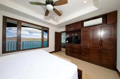 a bedroom with a bed and a ceiling fan at 360 Splendor 101A Ocean View Breakfast in Playa Flamingo